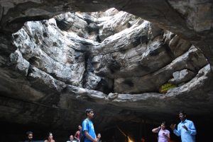 Visitors exploring the wide chambers of Belum Caves in Kadapa district